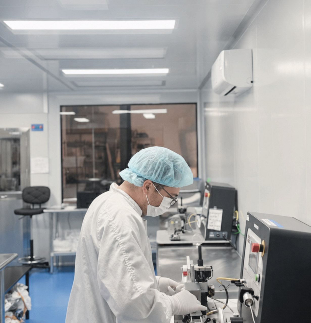 Cleanroom laboratory technician working at a medical-device manufacturing station